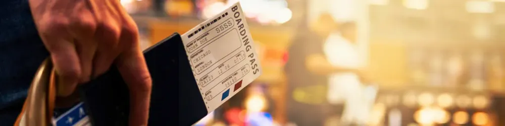 Boarding Pass Close Up In Crowded Airport Terminal